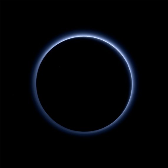 Image of a blue light surrounding a pitch black Pluto